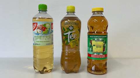 Drei Plastikflaschen mit bunten Etiketten und Deckeln